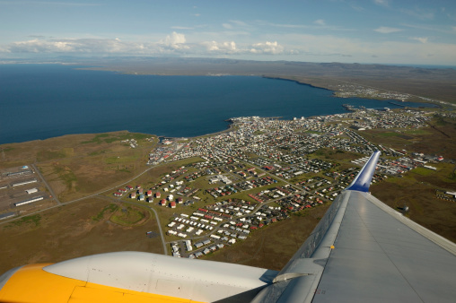 Scenic view through airplane window during take off from Keflavik airport in Iceland.