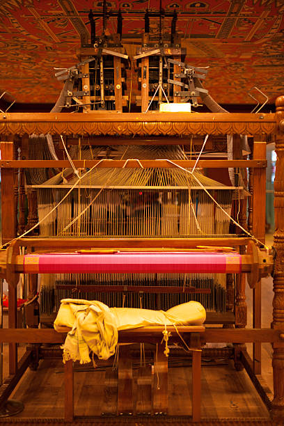 Rear Traditional Wooden Handloom The weaver's chair on the rear of a large wooden handloom in the process of making a pink Indian sari lacemaking photos stock pictures, royalty-free photos & images