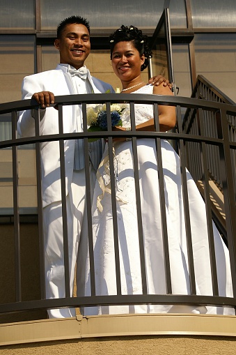 Bride and Groom posing on some stairs.