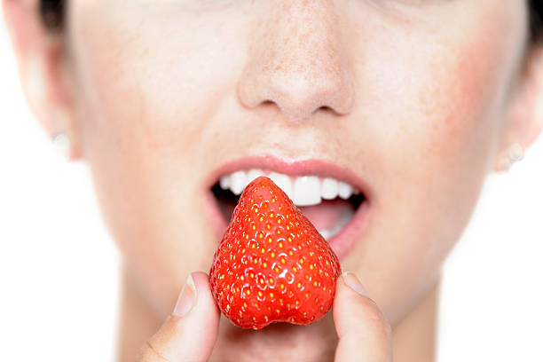 istock Woman eating fresh strawberry 178632681