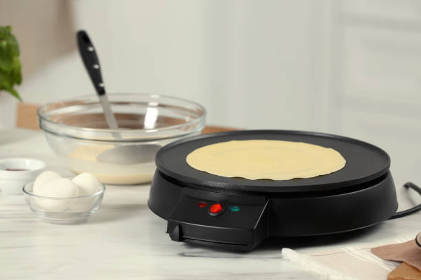 istock Electric maker with crepe and ingredients on white marble table in kitchen 1786334802