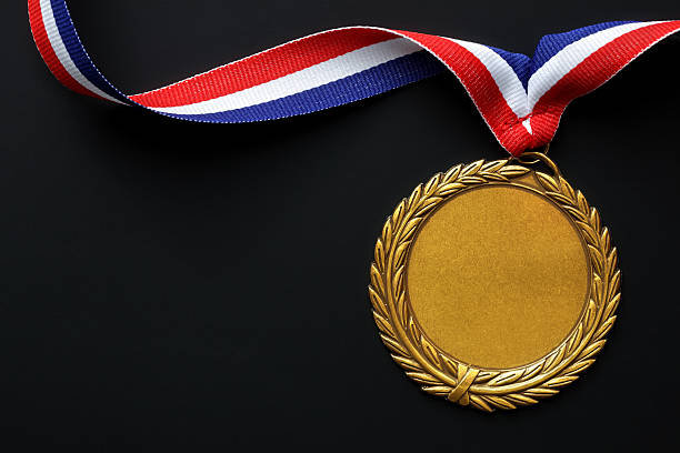 . gold medal "Gold medal on black with blank face for text, concept for winning or successPlease see similar pictures from my portfolio:" award ribbon photos stock pictures, royalty-free photos & images