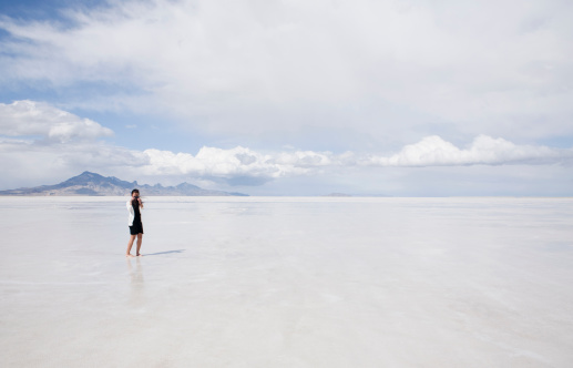Woman on Salt Flats taking photo with her smartphone