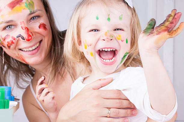 istock Mother and daughter with paint on faces 178634098