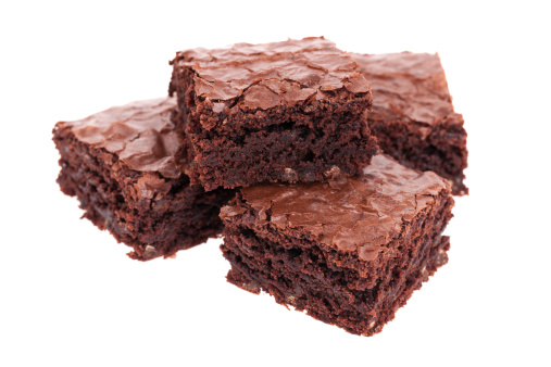 A stack of fresh baked brownies isolated on white
