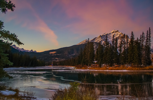 The mountain town of Banff in early winter. Banff is located in the Canadian Rockies in Banff National Park, in the province of  Alberta not far from Calgary.\nThe river in the picture is the Bow.
