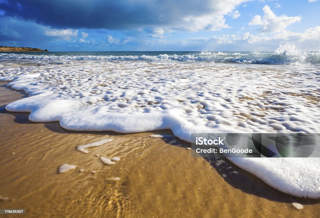 Wet Feet Waves wash over golden sand on Australian beach Australia Stock Photo