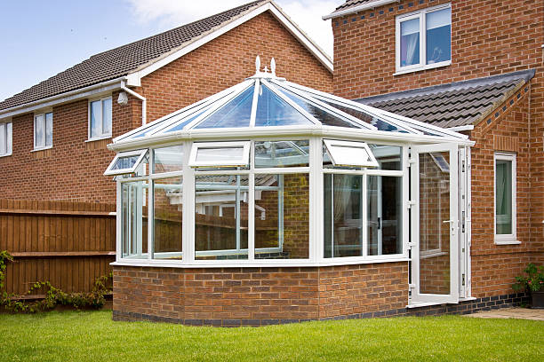 White-framed glass conservatory attached to house