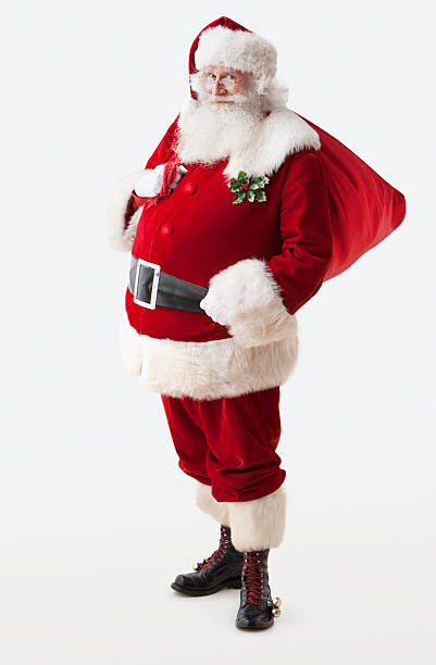 Santa Claus holding his gift bag Full body shot of Santa Claus holding his gift bag, he is looking at camera. vertical composition, Isolated on a white background santa claus stock pictures, royalty-free photos & images