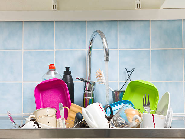 istock A messy sink full of dirty dishes with blue tile backsplash 178636228