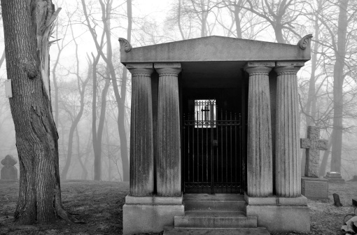 Mausoleum in a very foggy and scary looking graveyard.  Also perfect for Halloween and horror themes.