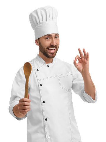 Mature chef with spoon showing ok gesture on white background