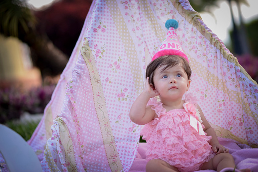 Adorable happy baby girl on pink background