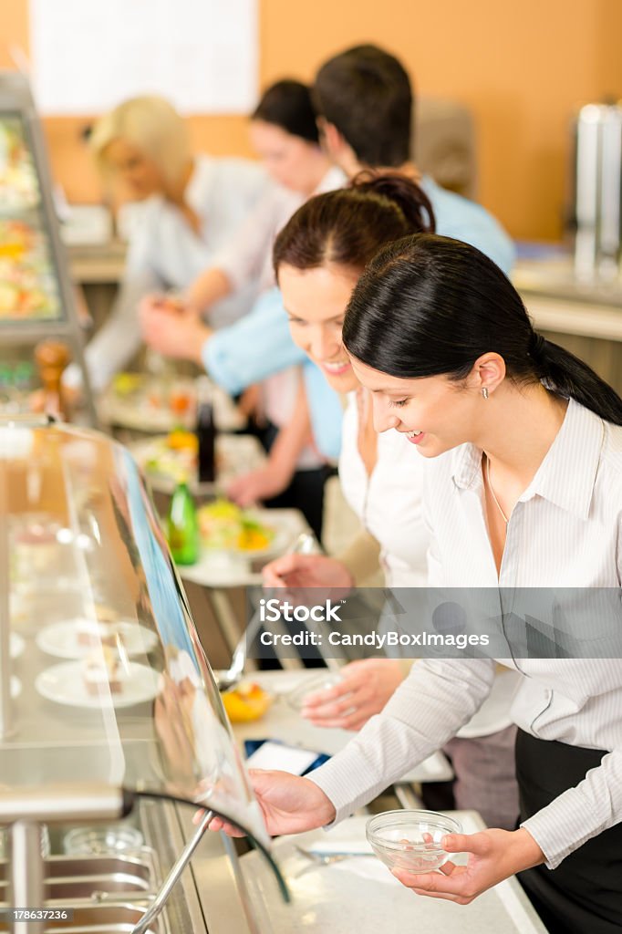 Cafeteria lunch two office woman choose food Cafeteria lunch two office colleagues woman choose food dessert self-service Cafeteria Stock Photo