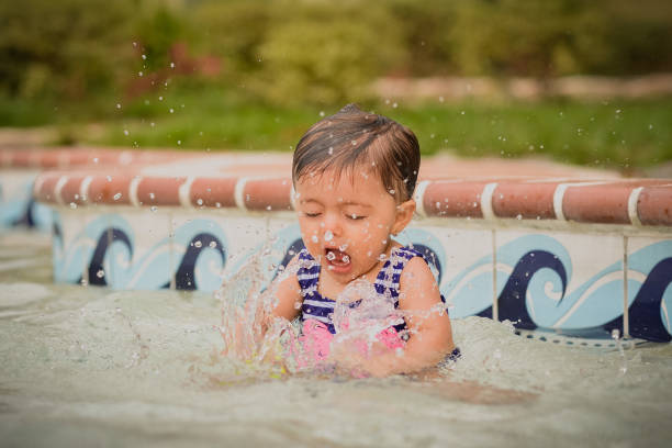 istock 9-month-old baby playing in pool on summer day 1786376768