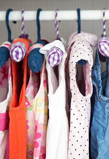 Pretty girls clothes on hangers stock photo