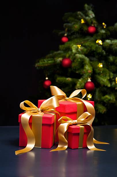 istock Three presents with gold ribbon 178638296