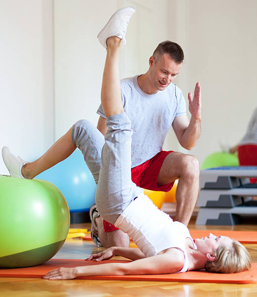 istock Woman exercising with personal trainer 178638875