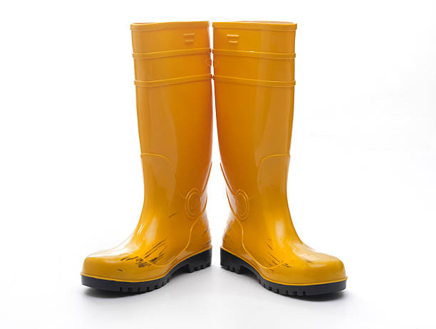 Yellow Rubber Boots Pair of yellow rubber boots boot stock pictures, royalty-free photos & images