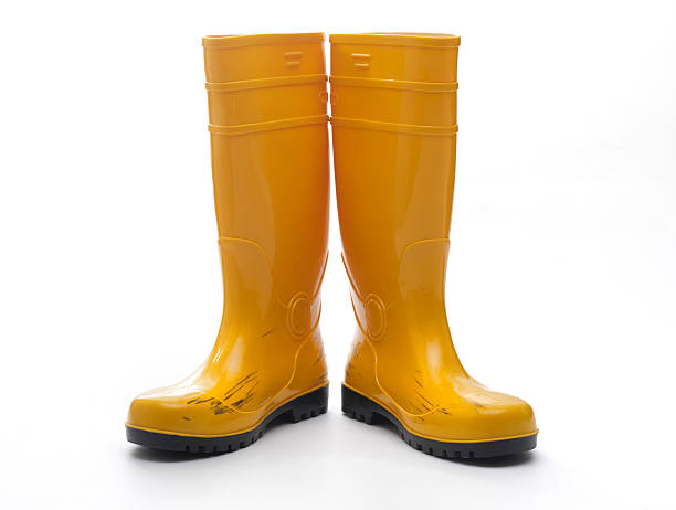 Yellow Rubber Boots Pair of yellow rubber boots pair stock pictures, royalty-free photos & images