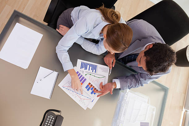 istock Above view of consultant analyzing statistics with her client 178639267