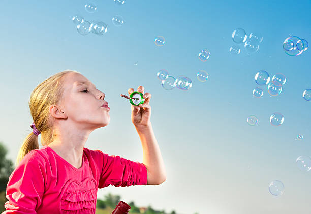 istock Girl making soap bubbles outside 178639897