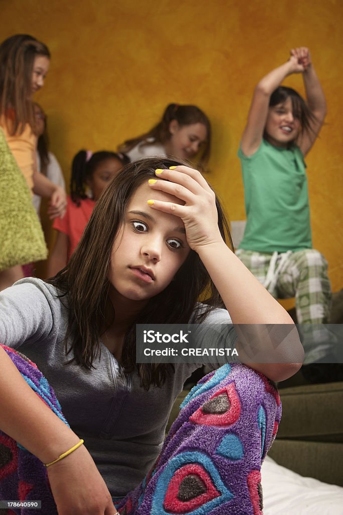 Overwhelmed babysitter Overwhelmed and tired teen girl babysitting wild kids Impatient Stock Photo