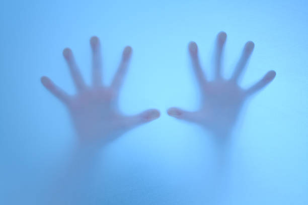 istock terrified hands on frosted glass 178640687