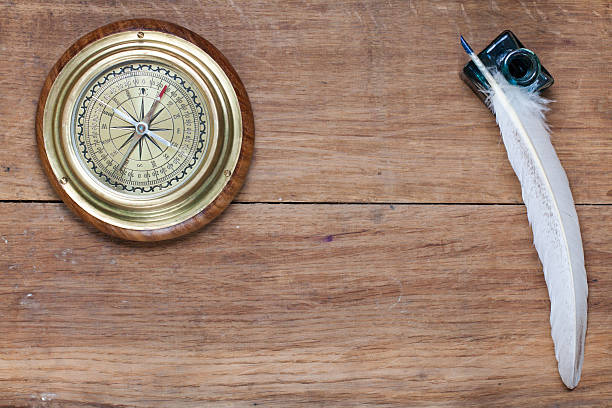 istock Compass, quill and inkwell on wood 178640700