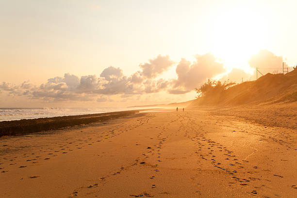 istock couple taking a walk on beach in sunset 178640949