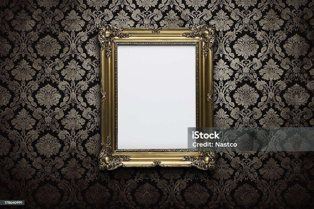 Blank frame at the wall with clipping path Ornate gold frame at grunge wallpaper with clipping path for the inside Picture Frame Stock Photo
