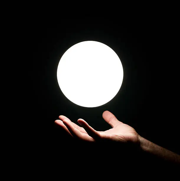 Photo of Light ball over human hand
