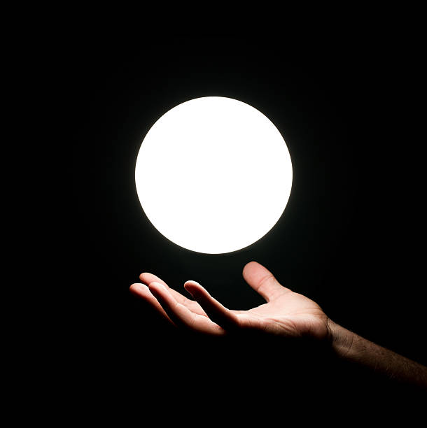 światło piłkę nad ręka człowieka - lighting equipment illuminated isolated on black part of zdjęcia i obrazy z banku zdjęć