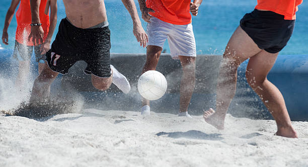 beach soccer team beach soccer  playing sand river stock pictures, royalty-free photos & images