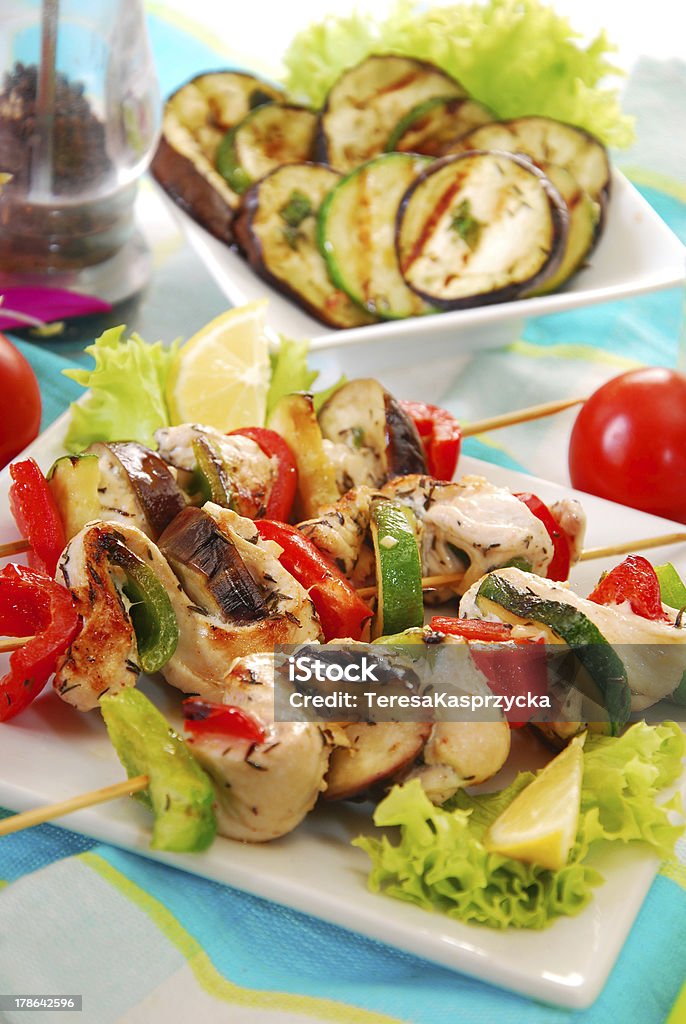 chicken and vegetable skewers "colorful skewers with chicken,aubergine,zucchini,red ang green pepper served with grilled vegetables salad" Barbecue - Meal Stock Photo