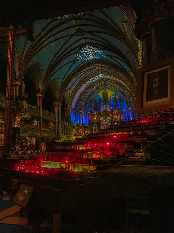 Candles in the foreground of the altar of the Notre-dame Basilica in Montreal. The basilica in located in the old part of town, Vieux Montreal.