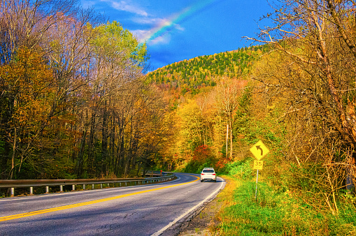 A rainbow briefly appears over a mountain road in central Vermont  on a October morning.