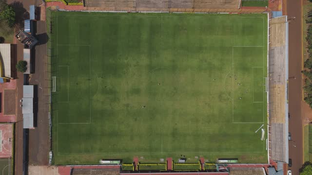 Aerial: soccer field, surrounded by greenery and buildings, in Misiones, Argentina