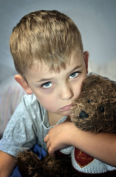 istock Small sad boy with eye bruise and teddy bear 178649445