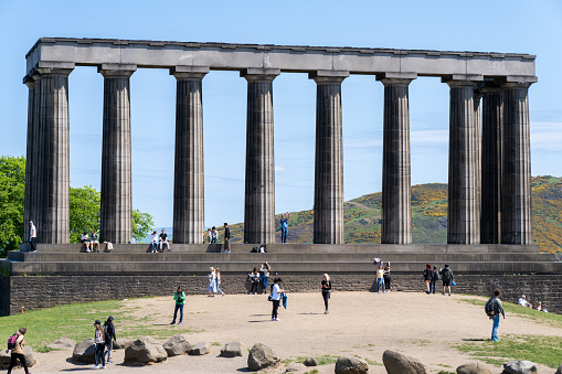 Edinburgh Scotland - June 3 2023: People Standing Around the Scottish National Monument in Edinburgh Scotland