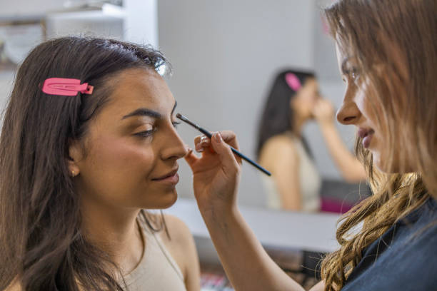 istock Make up artist applying eyebrow pencil on the client in her studio. 1786508959