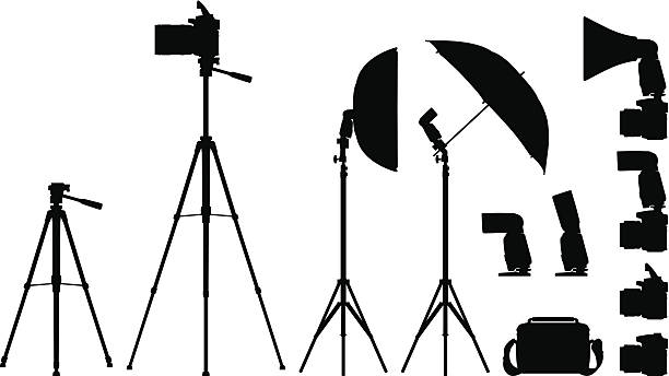 Camera and Equipments High detailed silhouettes of Cameras, Flashes, umbrellas, tripods, difusers isolated on white background. tripod stock illustrations