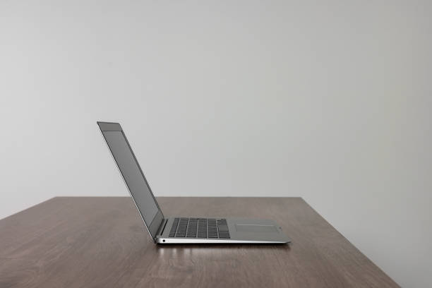 istock New modern laptop on empty wooden table indoors 1786564678
