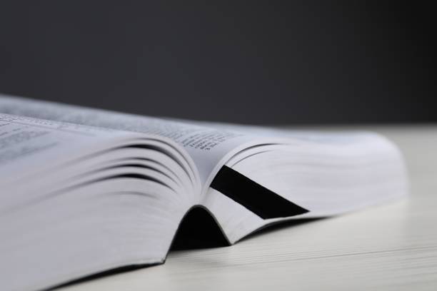 istock Open Bible on white wooden table, closeup. Space for text 1786574193