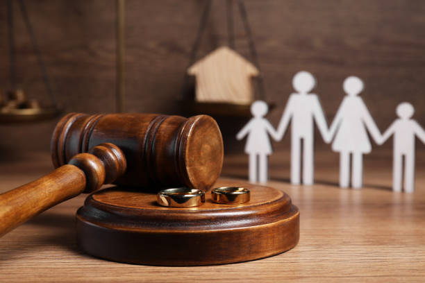 istock Divorce concept. Gavel and wedding rings on wooden table, space for text 1786574712