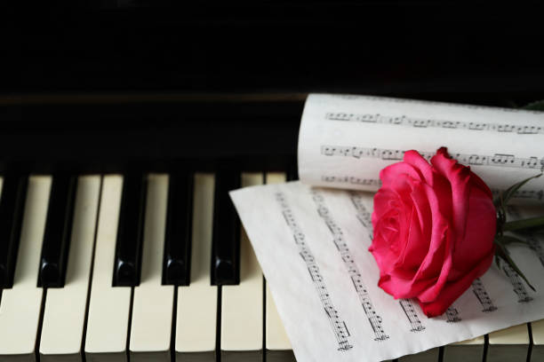 istock Beautiful pink rose and musical notes on piano keys 1786576269