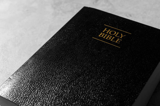 istock Bible with black cover on light gray table, closeup. Christian religious book 1786578324