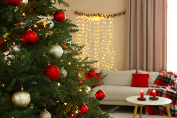 istock Beautiful Christmas tree decorated with baubles in stylish room. Interior design 1786595834
