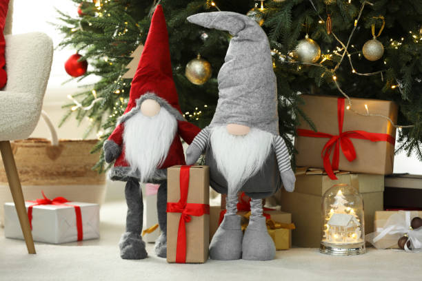 istock Funny decorative gnomes and gift boxes under Christmas tree indoors 1786597404