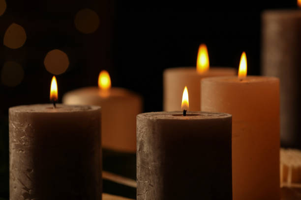 istock Closeup view of burning candles against blurred festive lights 1786617899